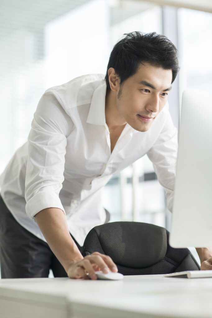 Young businessman using computer in office